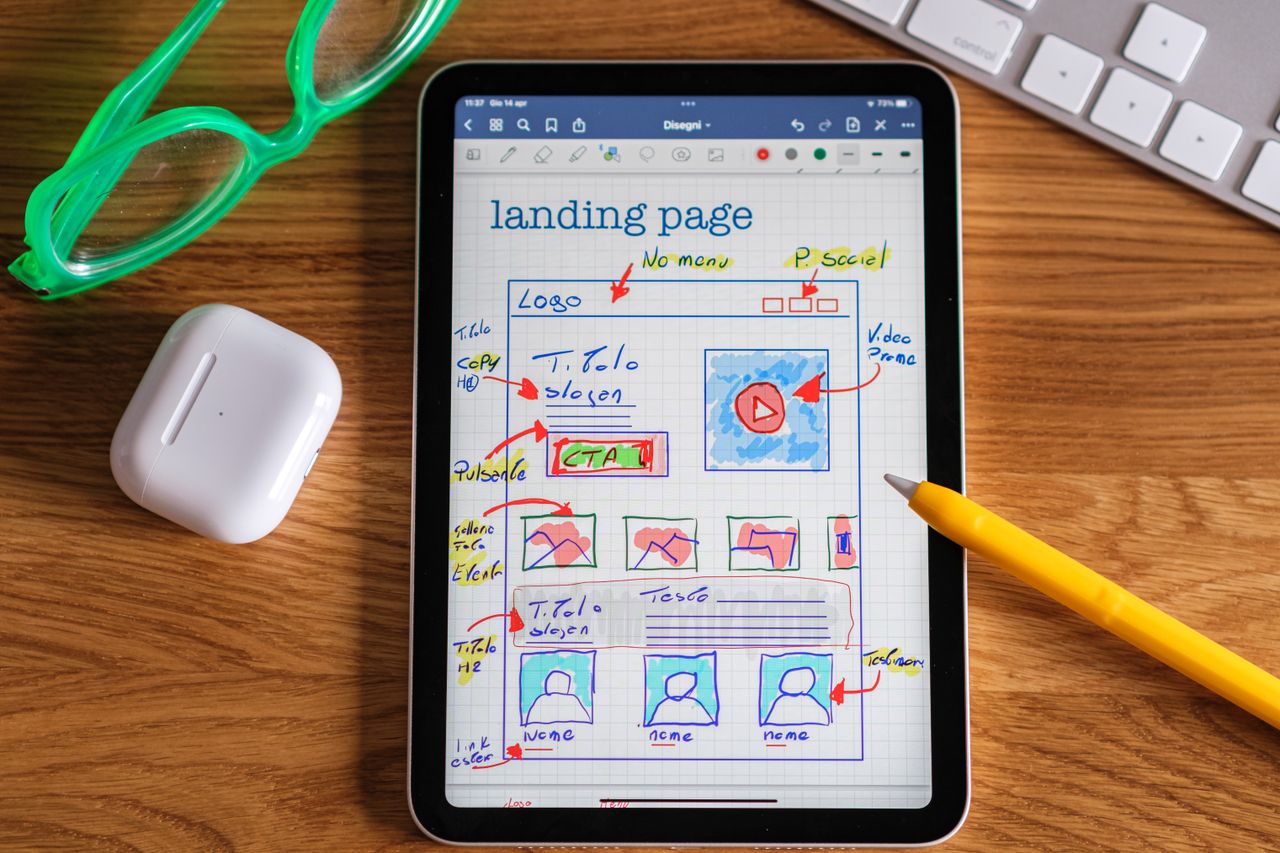 Portfolio Close-up of tablet showing a hand-drawn landing page design, ideal for web development concepts.